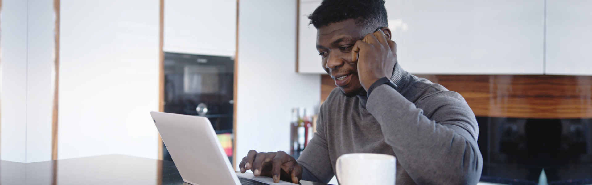 man calling while using laptop