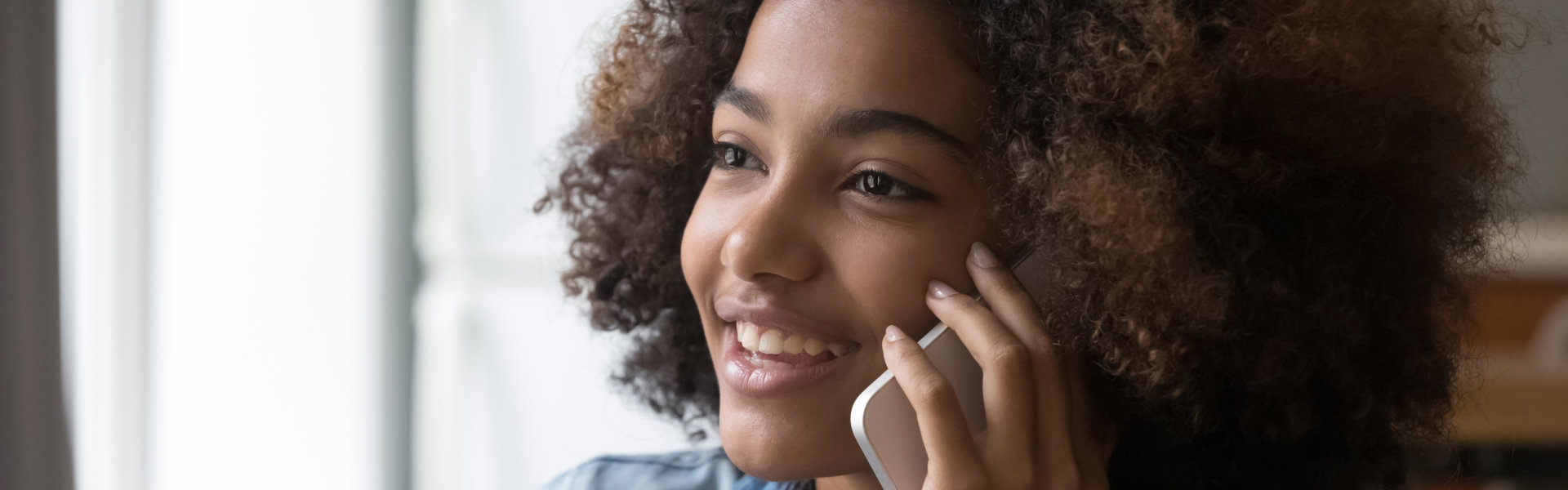 a girl holding her phone near hear head calling
